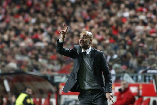 PORTUGAL, Lisbon: Josep Guardiola, head coach of Bayern Munich known as Pep Guardiola, reacts during the UEFA Champions League Quarter Final Second Leg match between SL Benfica and FC Bayern Munchen at Estadio da Luz on April 13, 2016 in Lisbon, Portugal. Bayern Munich reached the Champions League semi-finals for the fifth consecutive season. 