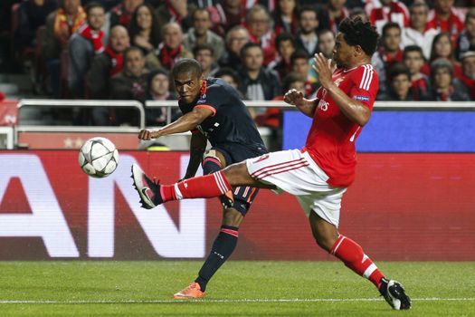 PORTUGAL, Lisbon: Douglas Costa de Souza of Bayern Munich in action with Eliseu Pereiro dos Santos of Benfica during the UEFA Champions League Quarter Final Second Leg match between SL Benfica and FC Bayern Munchen at Estadio da Luz on April 13, 2016 in Lisbon, Portugal. Bayern Munich reached the Champions League semi-finals for the fifth consecutive season. 