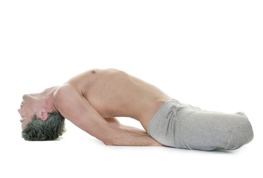 man doing yoga in front of white background