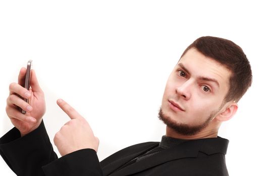 Casual businessman pointing with a finger at the phone with a raised eyebrow