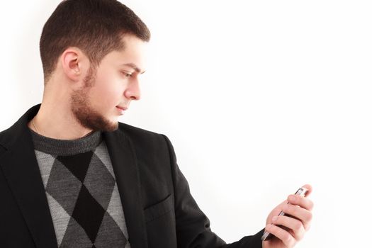 Casual businessman looking  at his phone screen isolated on white