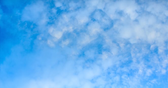 Blue sky with tiny clouds