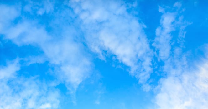 Blue sky with tiny clouds