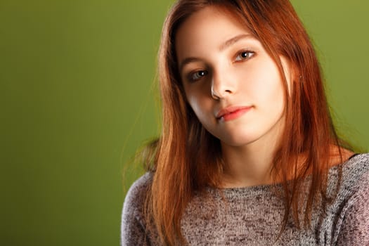 Portrait of teenage girl on green background