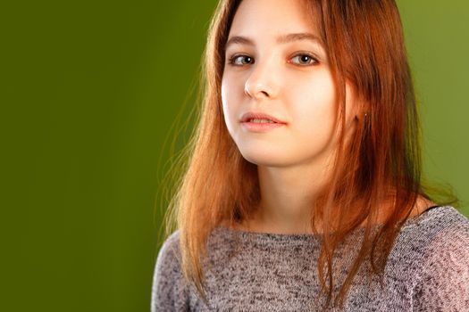 Portrait of cute girl with slightly open mouth on green