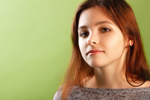 Portrait of teenage girl on green background