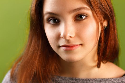 Portrait of teenage girl on green background