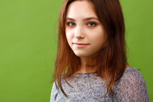 Portrait of teenage girl on green background