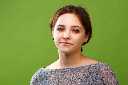 Portrait of teenage girl on green background