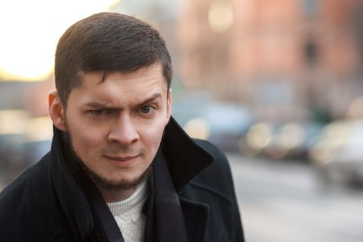 Portrait of a man with a raised eyebrow outdoor