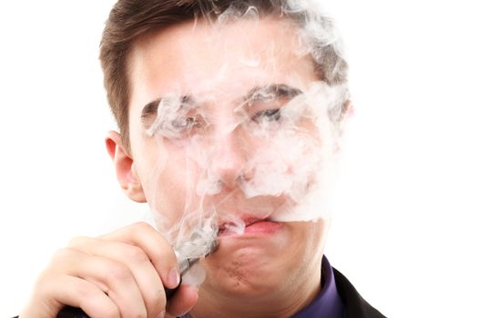 Portrait of a man in suit smoking an e-cigarette isolated on white. Let the steam out of his mouth