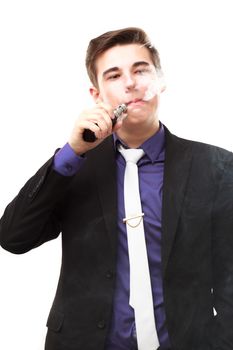 Portrait of a man in suit smoking an e-cigarette isolated on white. Let the steam out of his mouth