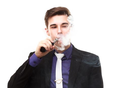 Portrait of a man in suit smoking an e-cigarette isolated on white. Let the steam out of his mouth