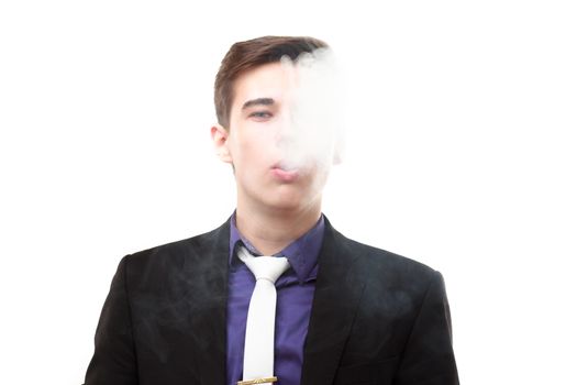 Portrait of a man in suit smoking an e-cigarette isolated on white. Let the steam out of his mouth