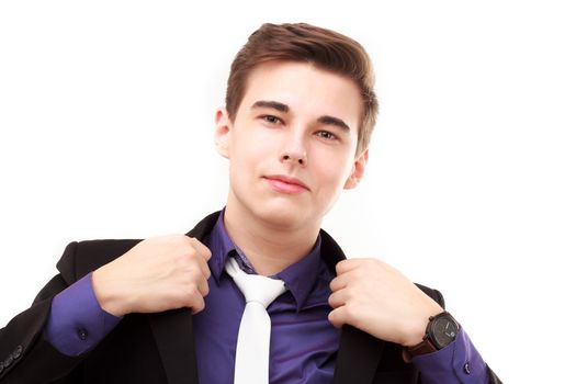 Portrait of an attractive young businessman correcting his jacket isolated on white