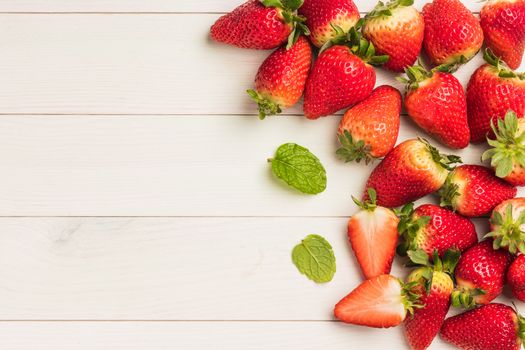 Fresh strawberries on wooden table. Top view with copy space