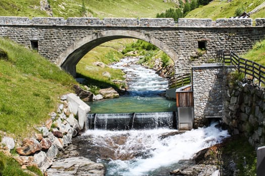 Bridge over mountain river. Alpine view