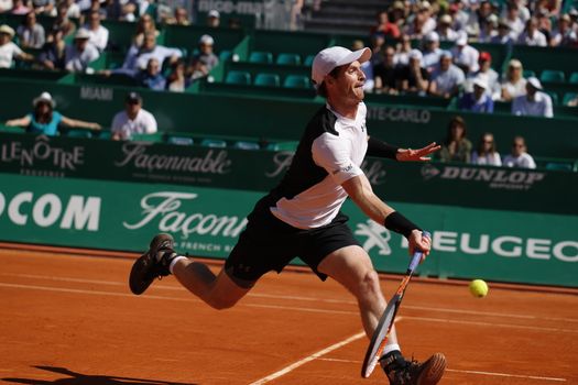 MONTE-CARLO, Monaco: British player Andy Murray stretches to hit a forehand during a game against Benoit Paire on April 14, 2016 as part of the Monte Carlo Rolex Masters.