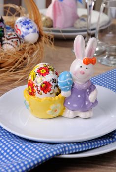 Easter Bunny stand with my drawing egg   on a festive table