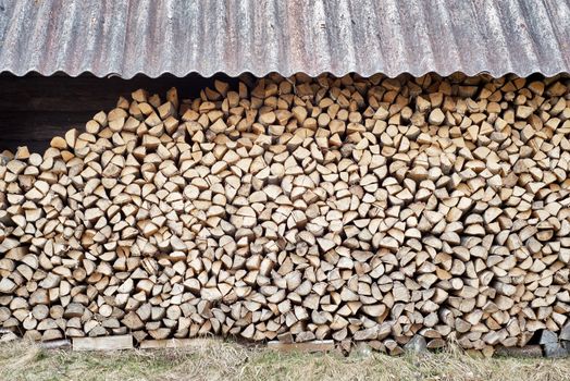 stack of chopped firewood in the woodshed