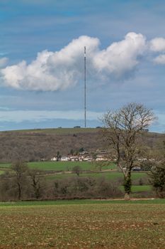 Old analogue TV mast, now used for mobile phone signal, in the middle of a rural setting.