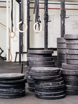Background photo of stacks barbell weights or plates at a indoor gym.

