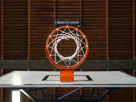 Photo of an indoor basketball hoop from below.

