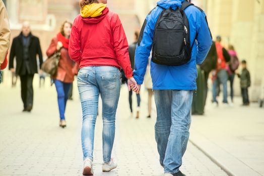 Young couple holding hands on the street