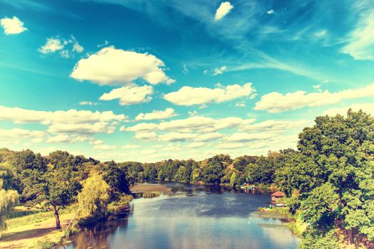 Landscape with river, forest, blue sky and clouds. Ukraine. Instagram colors.