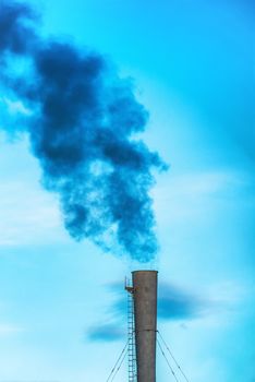 Industrial black toxic smoke from coal power plant on blue sky