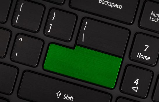 Laptop computer keyboard with blank green button for text