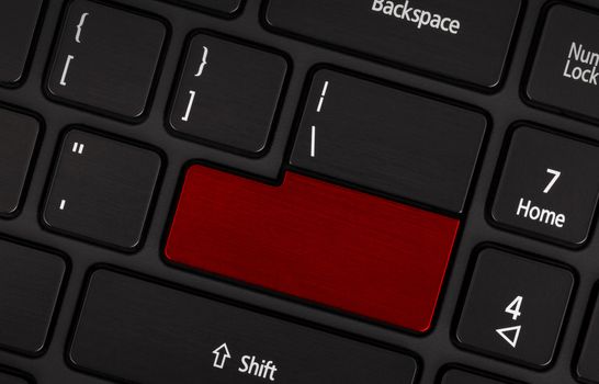 Laptop computer keyboard with blank red button for text