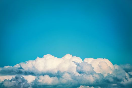 White clouds on the blue sky. Nature background, instagram colorized