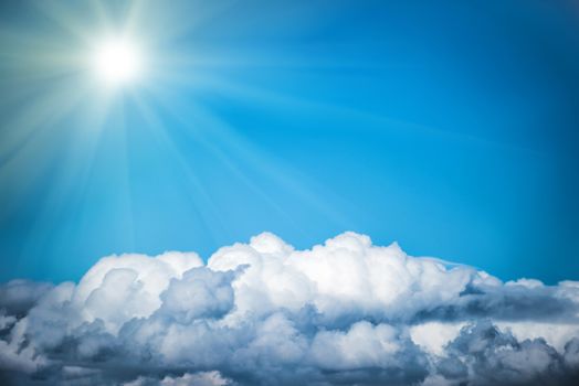 White clouds and bright sun on the blue sky. Nature background