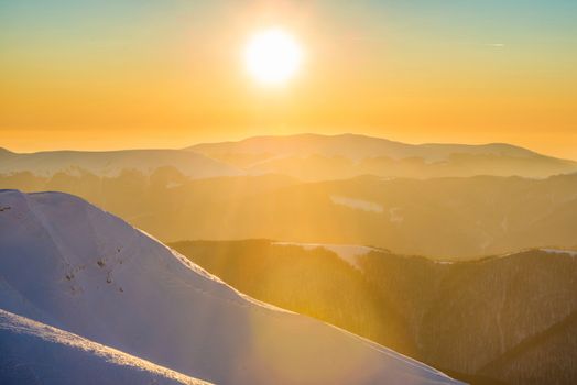 Sunset in winter mountains covered with snow.