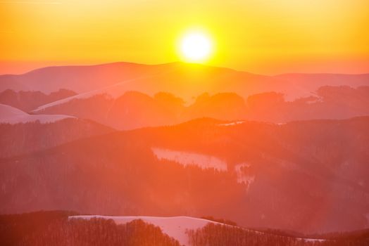 Sunset in winter mountains covered with snow.