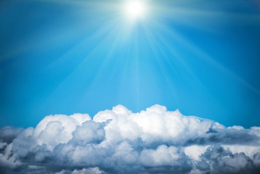 White clouds and bright sun on the blue sky. Nature background