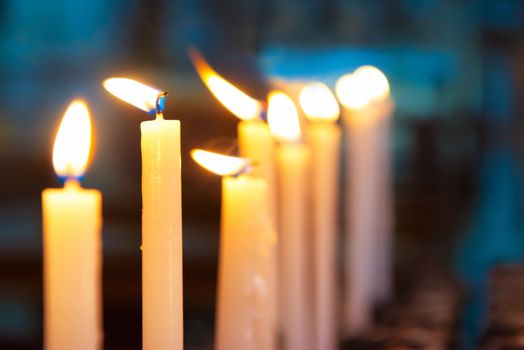 Light of candles in the church on the black background