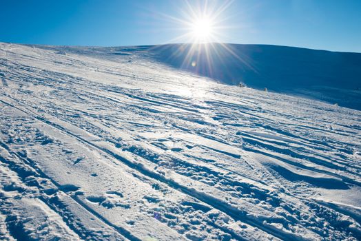 Bright sun in winter mountains covered with snow.