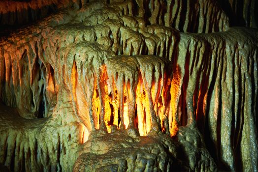 Unique cave formation- big stalactites, stalagmites and columns. Shooting deep under ground with candle light