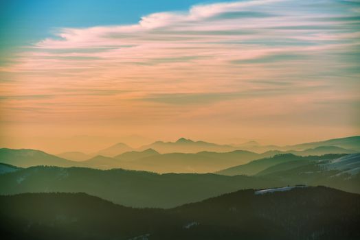 Sunset in winter mountains covered with snow.