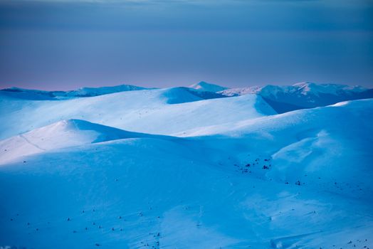 Sunset in winter mountains covered with snow