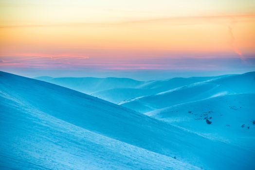 Sunset in winter mountains covered with snow