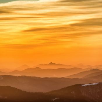 Sunset in winter mountains covered with snow.