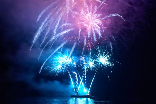 Blue colorful holiday fireworks on the black sky background.