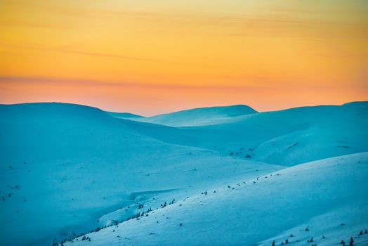 Sunset in winter mountains covered with snow