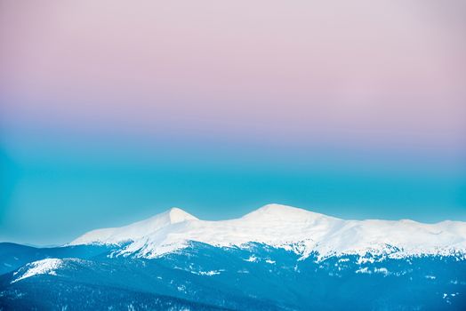 Sunset in winter mountains covered with snow. Ukraine, Hoverla and Petros