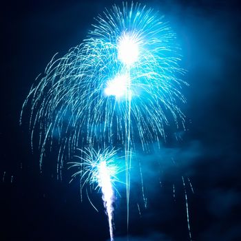 Blue fireworks on the black sky background