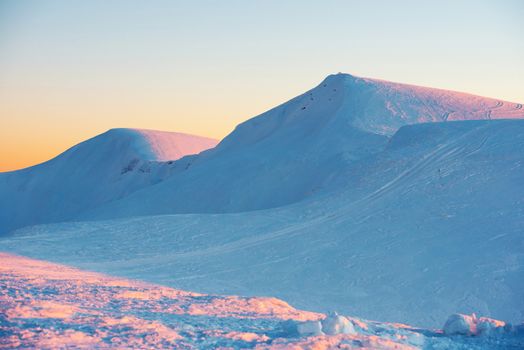 Sunset in winter mountains covered with snow.