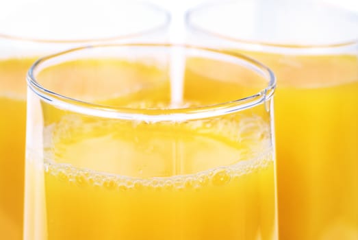 Glasses full of fresh orange juice isolated on white background